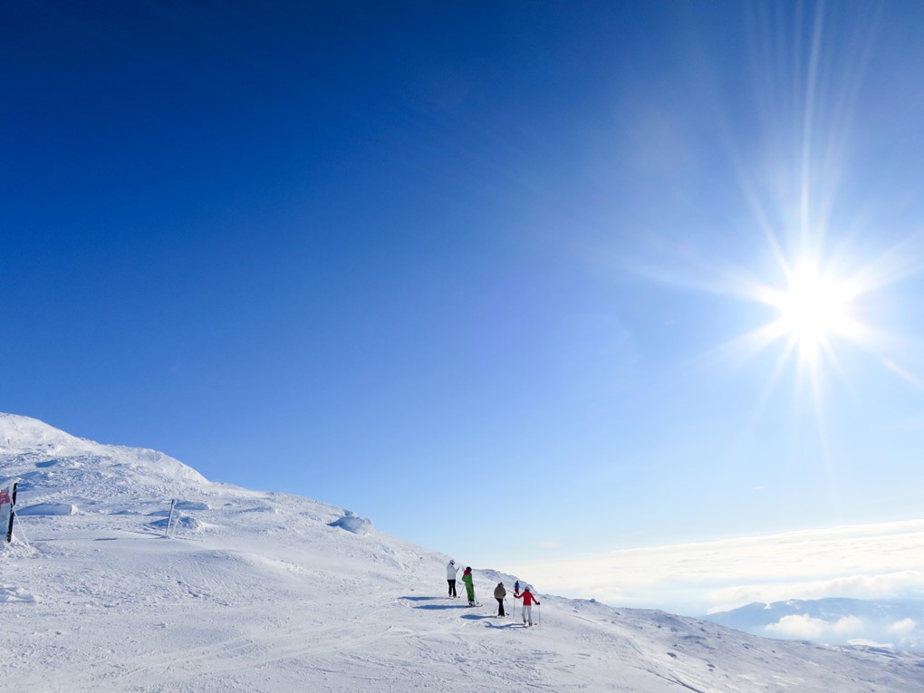 Leende kvinna som cyklar mot kameran.
